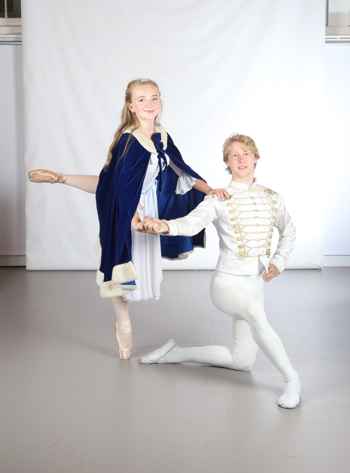 Clara leaning on the Nutcracker's knee